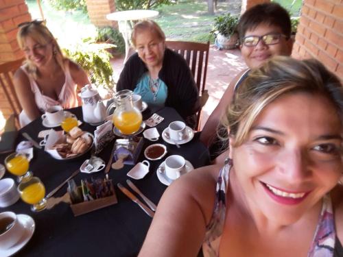 een groep mensen die aan een tafel zitten met sinaasappelsap bij posada cerro los nogales in San Agustín de Valle Fértil