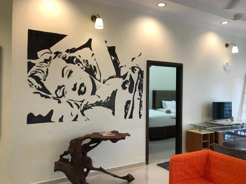 a living room with a painting on the wall at Wan's Beach Guest House in Dungun