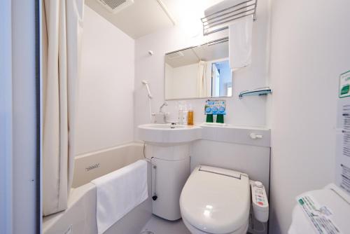 a small bathroom with a toilet and a sink at Super Hotel JR Nara Ekimae Sanjo Dori in Nara