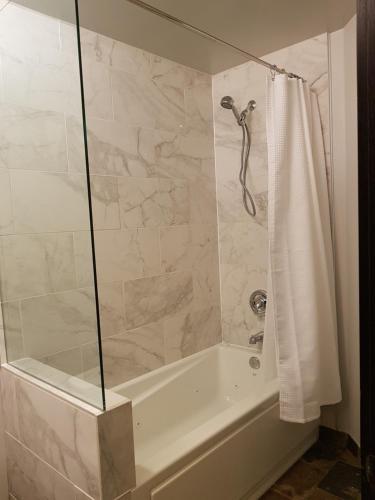 a bathroom with a bath tub with a shower curtain at Paradise Resort Club and Spa in Canmore