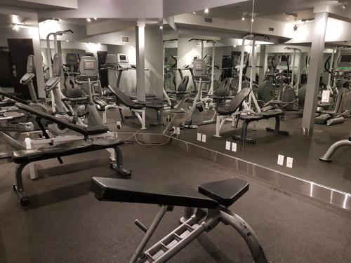 a gym with a lot of cardio equipment in it at Paradise Resort Club and Spa in Canmore