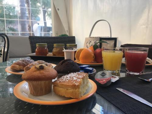 a table with two plates of muffins and drinks at B&B Liberty 900 in Catania
