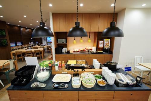a counter with many plates of food on it at Super Hotel JR Nara Ekimae Sanjo Dori in Nara