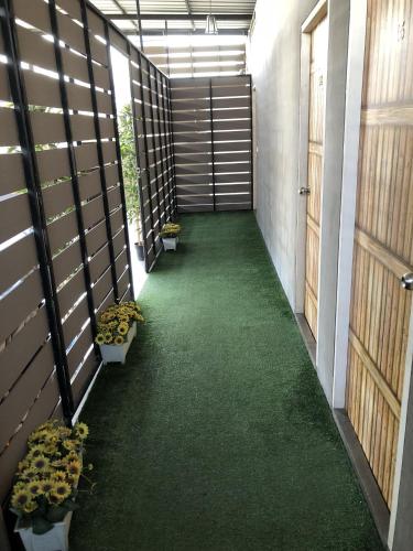 a hallway with potted plants on the side of a building at VX The Fifty in Bangkok