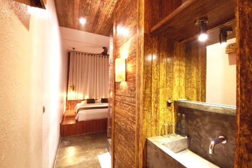 a bathroom with a tub and a bedroom with a bed at Echoland Boutique Bed And Breakfast in Canggu