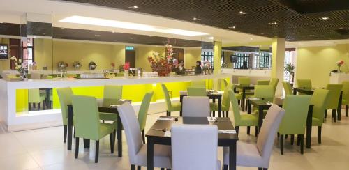 a restaurant with tables and chairs and a bar at De Palma Resort Kuala Selangor in Kuala Selangor
