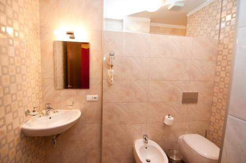 a bathroom with a sink and a toilet at Road Star Hotel in Dnipro