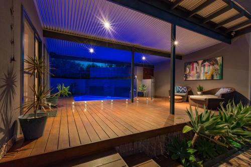 a house with a deck with purple lights at Salt The Studio in Kalbarri