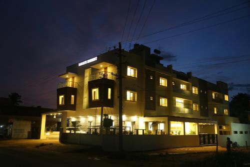 a large building with lights on at night at Samarth Residency in Hospet