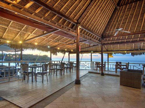 レンボンガン島にあるMushroom Beach Bungalowsのテーブルと椅子が備わるレストランで、水辺の景色を望めます。