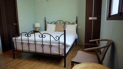 a bedroom with a bed with white sheets and white pillows at Warm Breeze Stay in Hualien City
