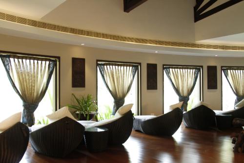 a living room with couches and windows at The Lalit Resort & Spa Bekal in Bekal