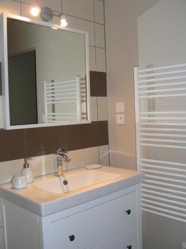 une salle de bain avec un lavabo et un miroir dans l'établissement Le Mas de Magnaou, à Rosières