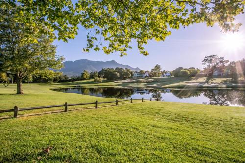 a view of a pond in a park at Fancourt Hotel in George