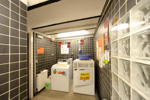 a small kitchen with two refrigerators in a room at Safestay Barcelona Gothic in Barcelona