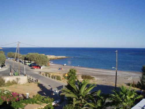 a view of a road with the ocean in the background at Seaside Studios Kirania in Kiotari
