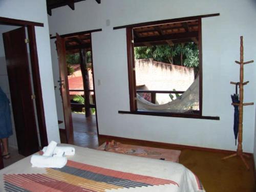 a room with a bed and a window with a view at Pousada Bambu Brasil in Sao Jorge