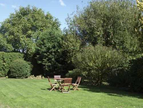 two chairs and a table in a grass field at The Coach House in Hereford