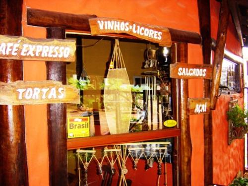 a store with signs on the front of a store at Pousada Bambu Brasil in Sao Jorge