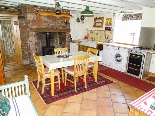 a kitchen with a table and chairs and a stove at The Lookout in Tweedmouth