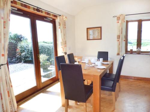 a dining room with a wooden table and chairs at The Old Granary in Haverfordwest