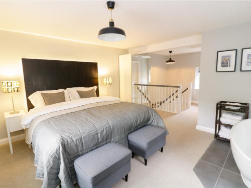 a bedroom with a large bed and a bath tub at The Old Post Office in Garstang