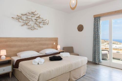a bedroom with a bed with two towels on it at Arhontou in Apollonia