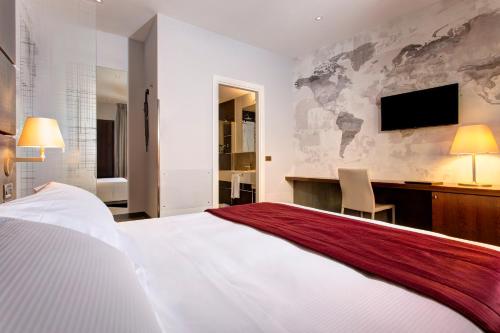 a hotel room with a bed and a desk and a television at Hotel Nazionale in Rome