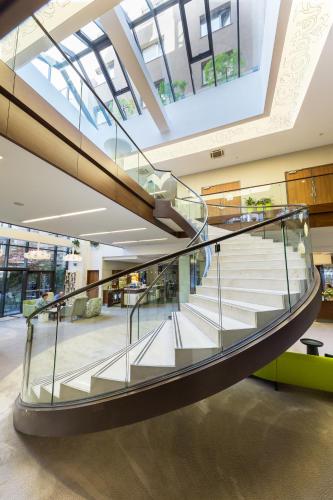 a glass spiral staircase in a building withwindows at Capital Plaza Hotel in Bucharest