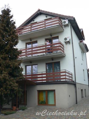 a person sitting on the balcony of a building at Centrum wypoczynku in Ciechocinek