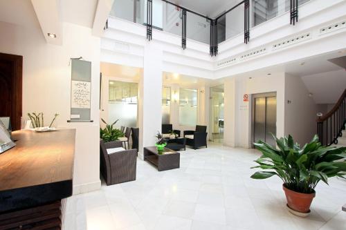 an office with a lobby with tables and chairs at Monjas del Carmen Hotel in Granada