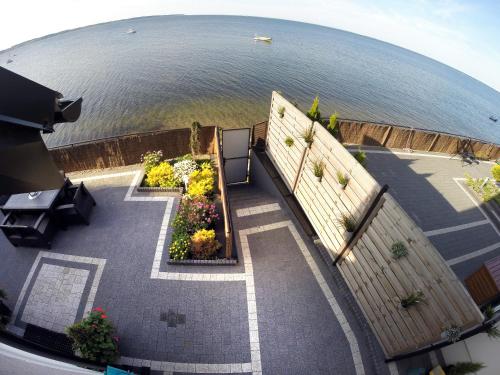 an aerial view of a patio next to the water at Apartamenty 5 metrów od morza in Rewa