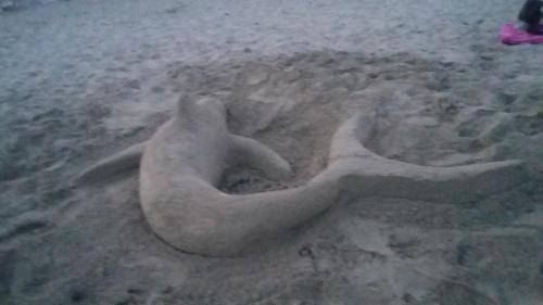 a sand sculpture of a person laying in the sand at Casa Roby 120 mt Beach in Fontane Bianche