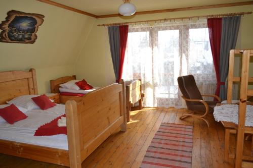 a bedroom with two bunk beds and a window at Durda in Poronin