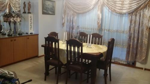 a dining room with a table and eight chairs at Heavenly Farm B & B Tasmania in Boat Harbour