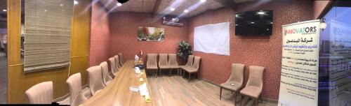 a conference room with a long table and chairs at Castle Hotel in Al Başrah