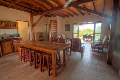 a kitchen and dining room with a wooden table and chairs at Bay View Lodge in Miramar
