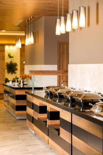 a kitchen with a counter with pots and pans at Mercure Tetovo in Tetovo
