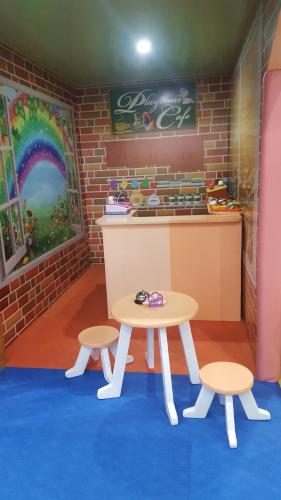a table and two stools in front of a counter at MJ's Residences Garden Hotel in Moalboal