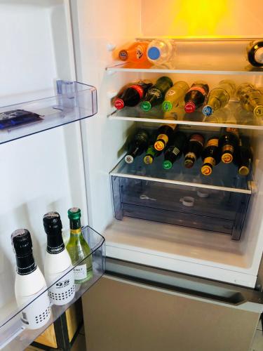 an open refrigerator filled with lots of bottles of wine at Pili Pili Boutique Hotel in Kigali