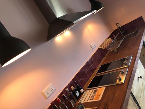 a kitchen with a counter with a mirror at Pili Pili Boutique Hotel in Kigali