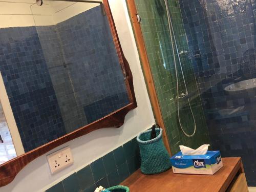 a bathroom with a glass shower and a sink at Pili Pili Boutique Hotel in Kigali