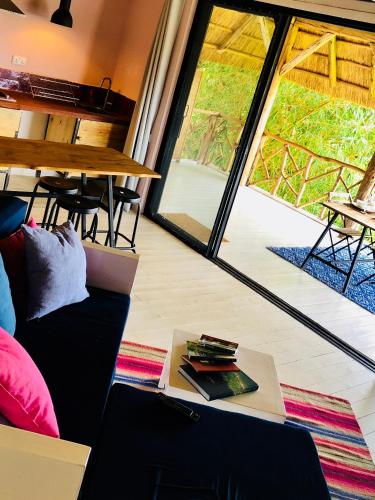 a room with a couch and a table and a window at Pili Pili Boutique Hotel in Kigali