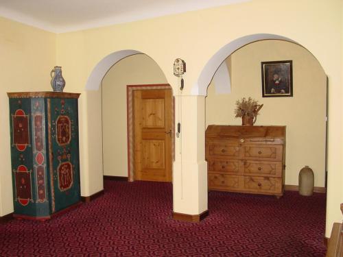 a room with a dresser and a wooden door at Plonerhof in Lagundo