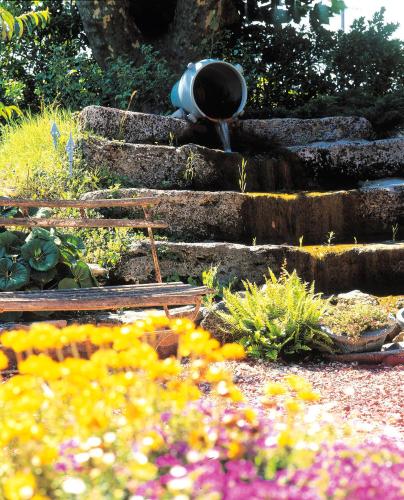 a garden with a bunch of plants and flowers at Hôtel du Parc, Avignon Est, The Originals City, in Entraigues-sur-la-Sorgue