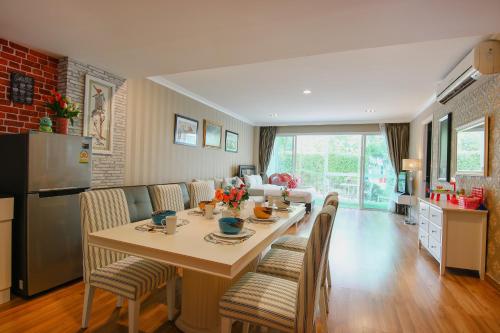 a kitchen and living room with a table and chairs at My Resort Hua Hin B111 in Hua Hin