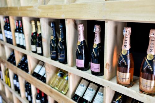 a bunch of bottles of wine on a shelf at Pili Pili Boutique Hotel in Kigali