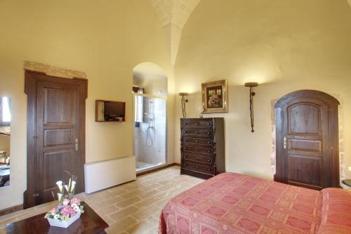 a bedroom with a bed and a dresser at Tenuta Monacelli Lecce in Lecce