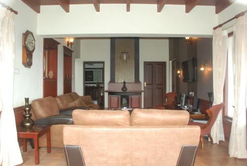 a living room with a couch and a table at Colonial 4 B/R Home, Great for Families, Coonoor in Coonoor