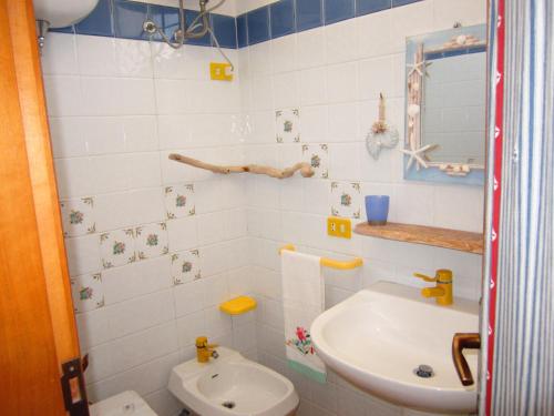 a bathroom with a white toilet and a sink at Le Case dei Pescatori - Casetta Faraglioni in Ponza